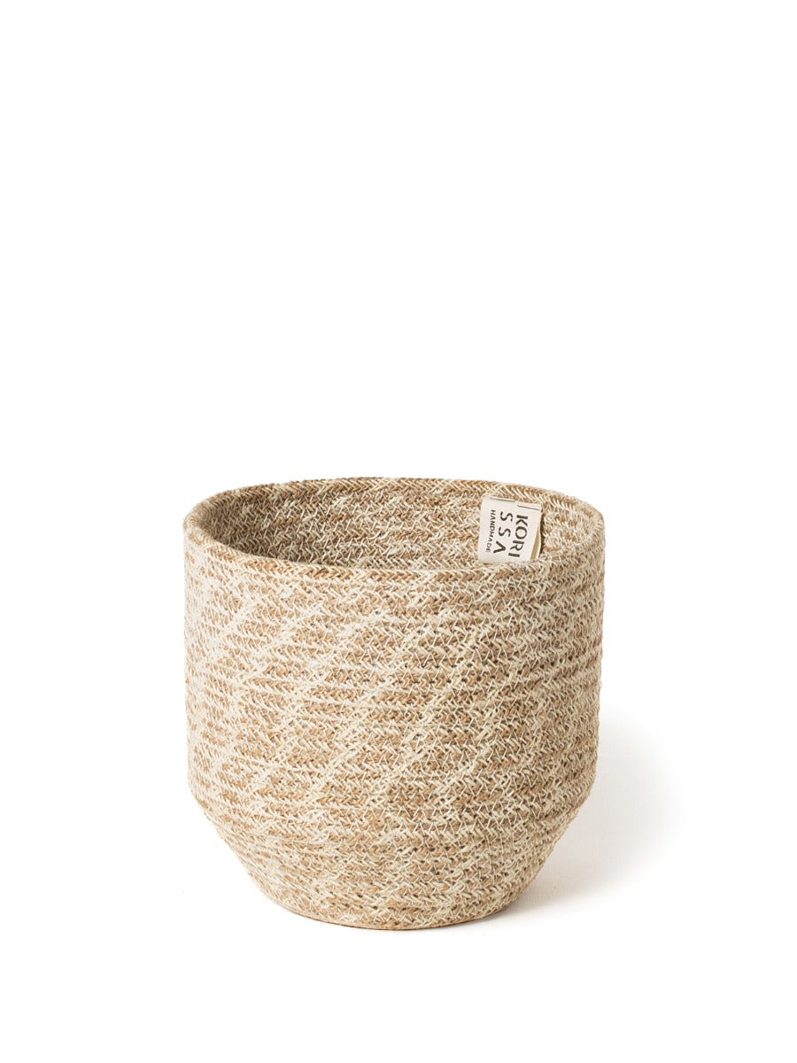 Woven jute storage bin with natural tan texture and tapered cylindrical shape for plants and home decor