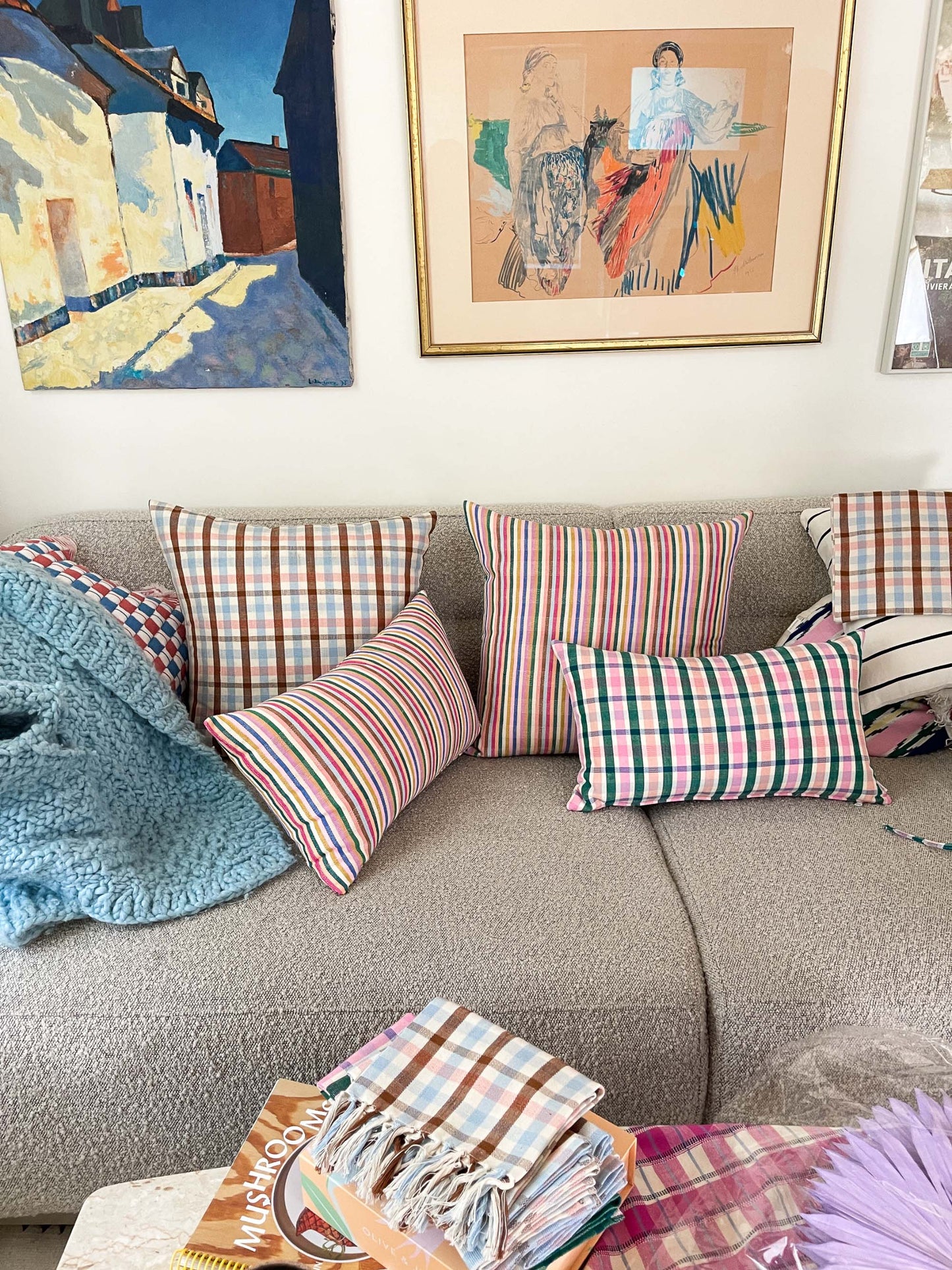 Colorful striped and plaid square throw pillow with rainbow stripes and geometric pattern on natural linen fabric
