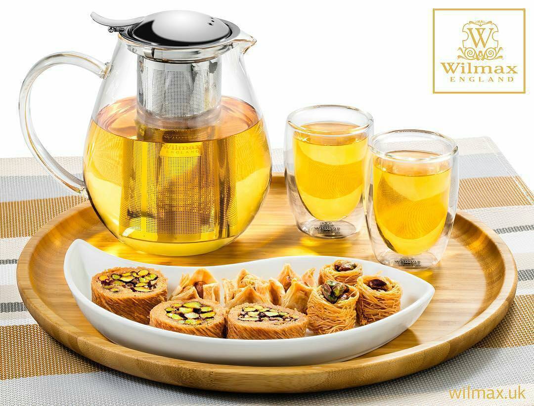 Bamboo round platter 14 inch holding pastries and tea set with glass infuser pitcher and cups