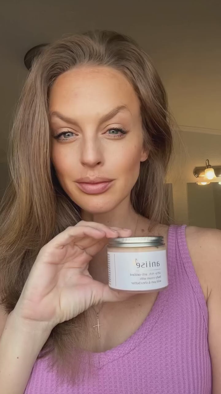 Anti-oxidant wild yam body cream in white glass jar with silver lid, natural skincare product