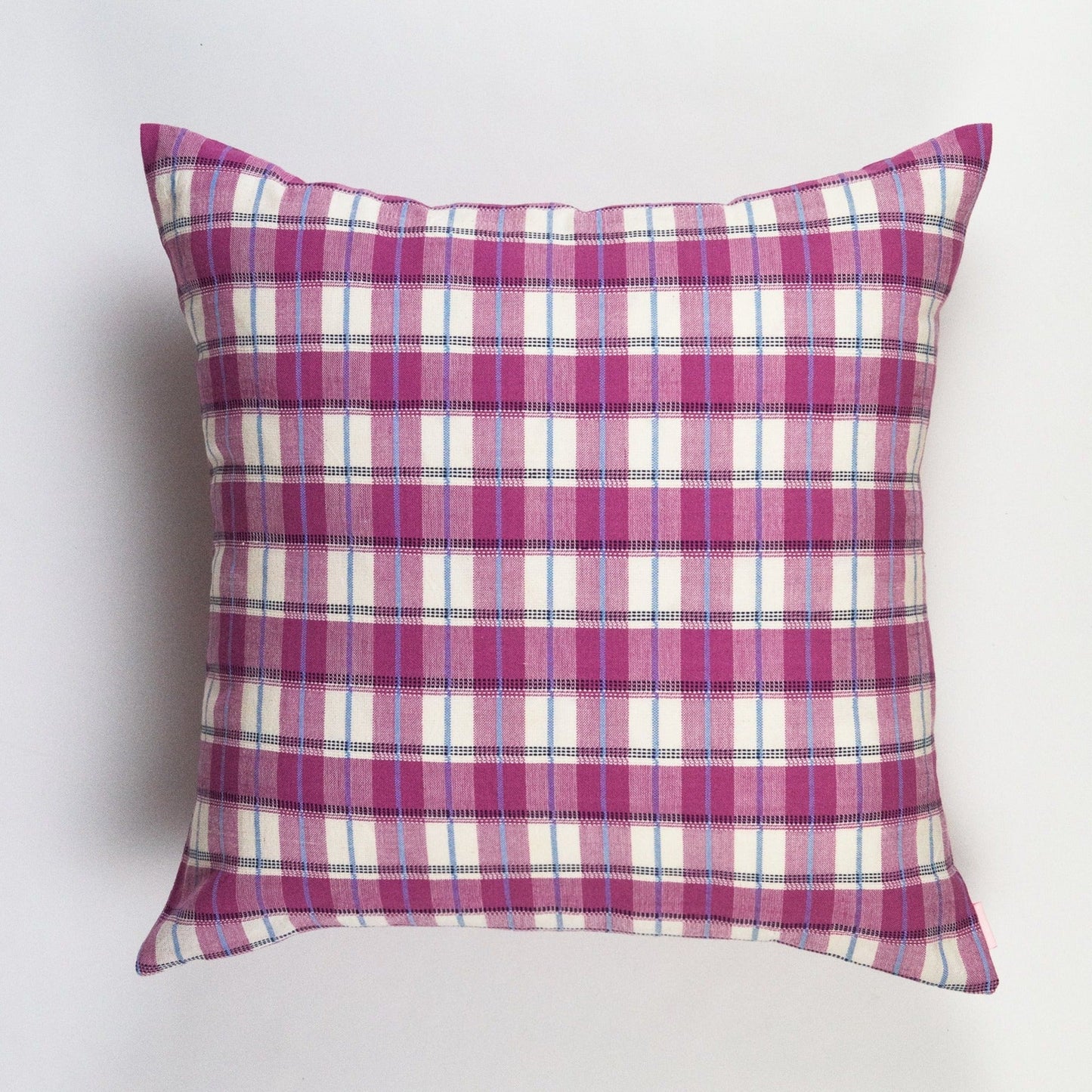 Pink and white gingham plaid throw pillow with blue accent stripes and woven cotton texture