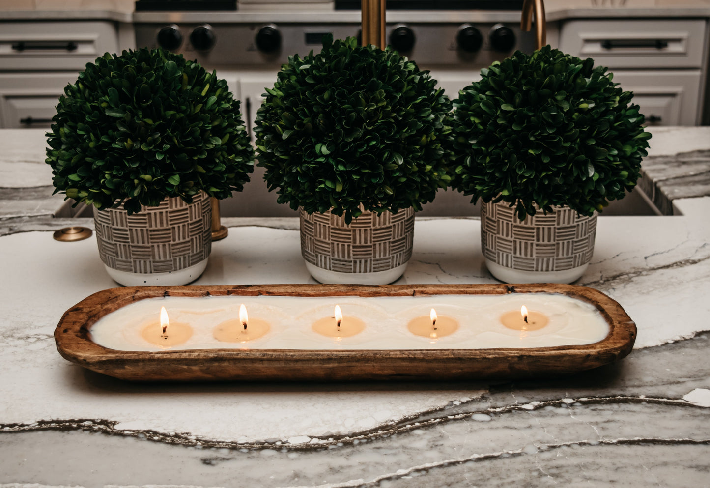 Five-wick soy candle in wooden dough bowl with cream interior, rustic farmhouse style