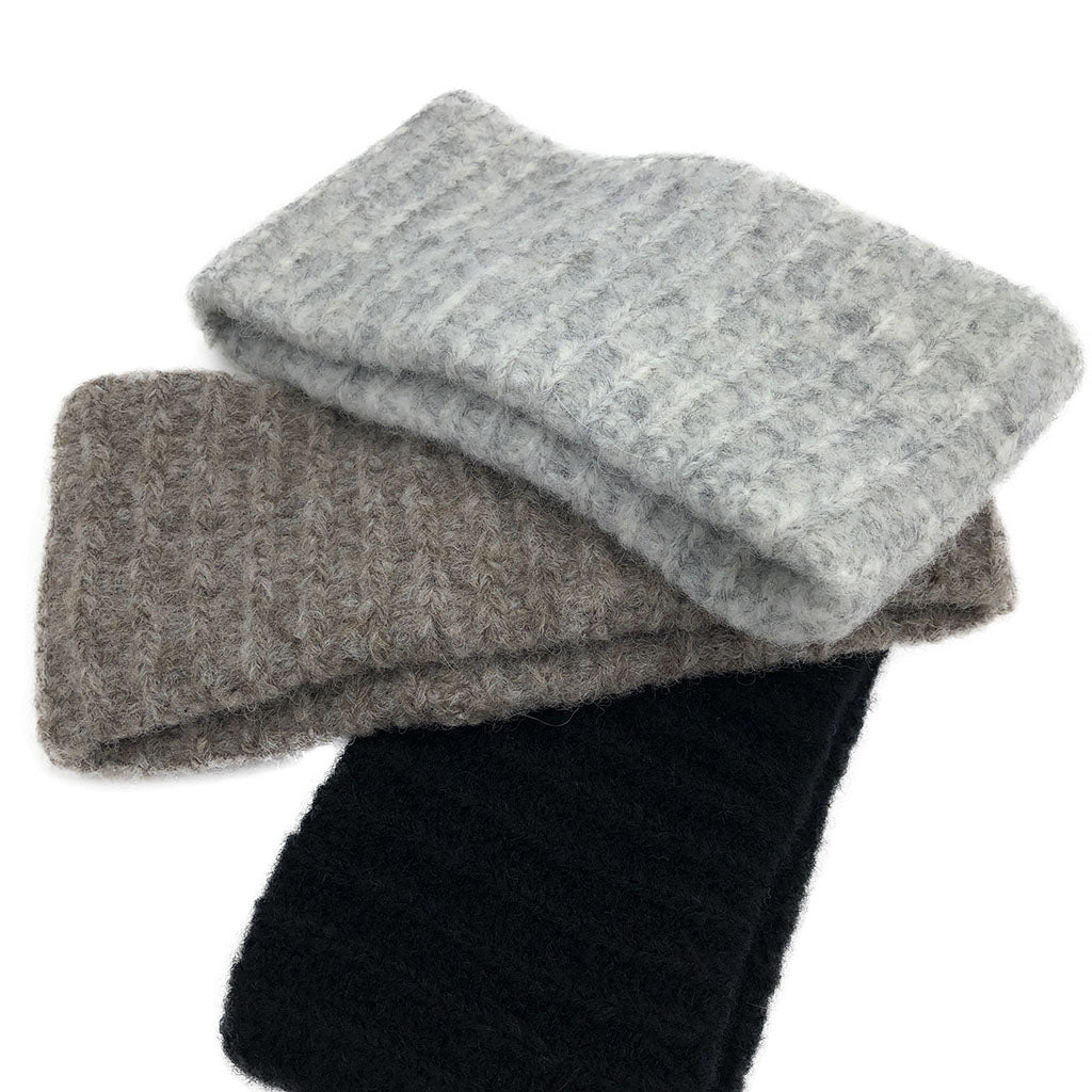 Ribbed alpaca ear warmers in light gray, taupe, and black with soft knit texture