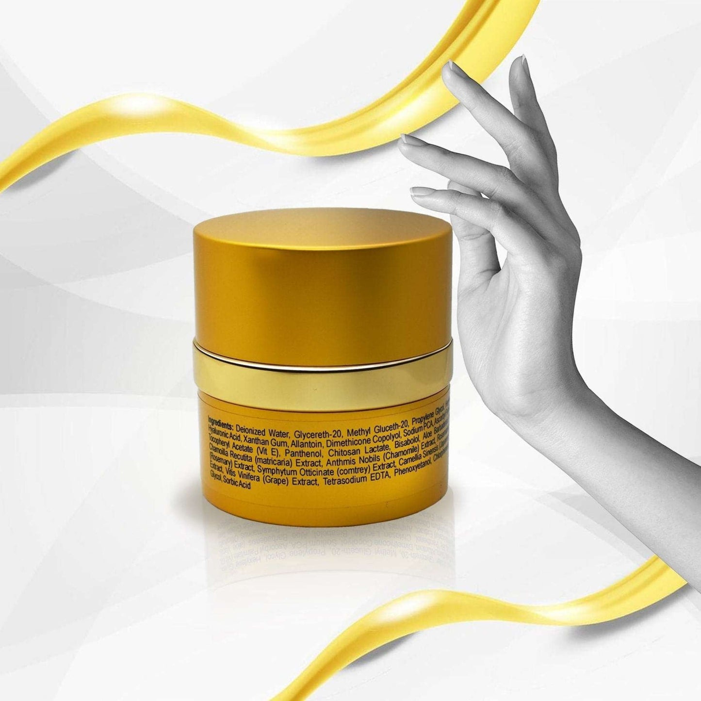 Gold luxury face cream jar with natural anti-aging serum, held by hand with flowing yellow ribbon accent