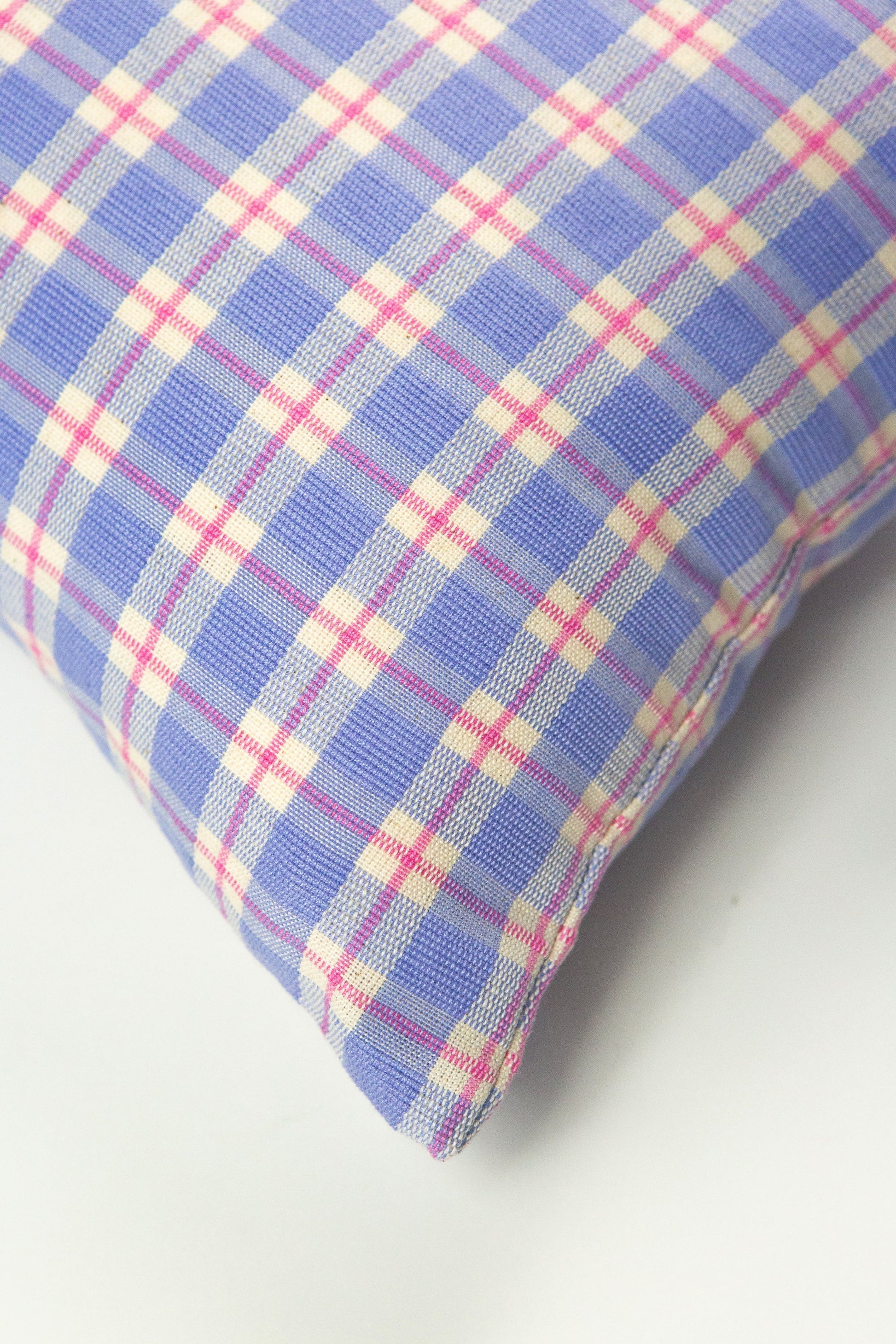Periwinkle plaid throw pillow with pink, cream, and gray woven check pattern, textured linen blend fabric