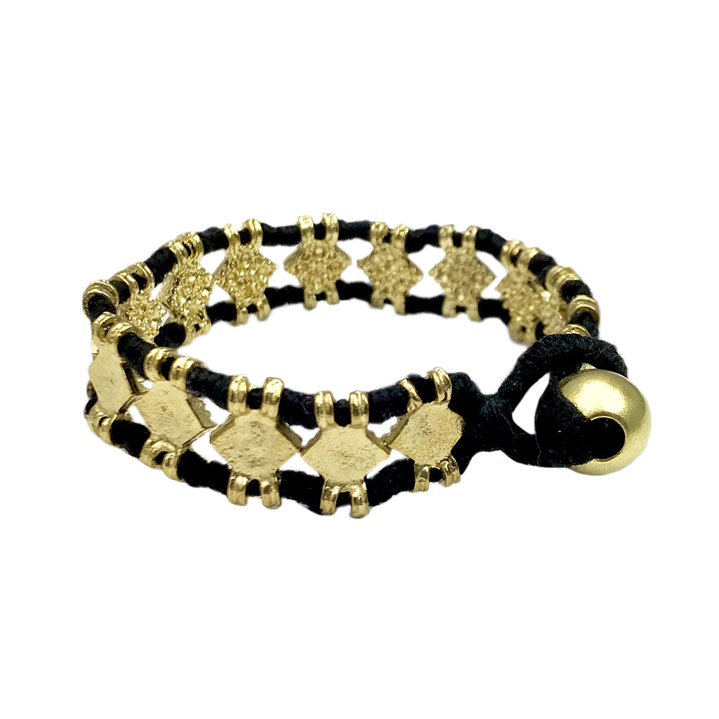Black cord bracelet with gold geometric charms and brass ball closure, artisan jewelry