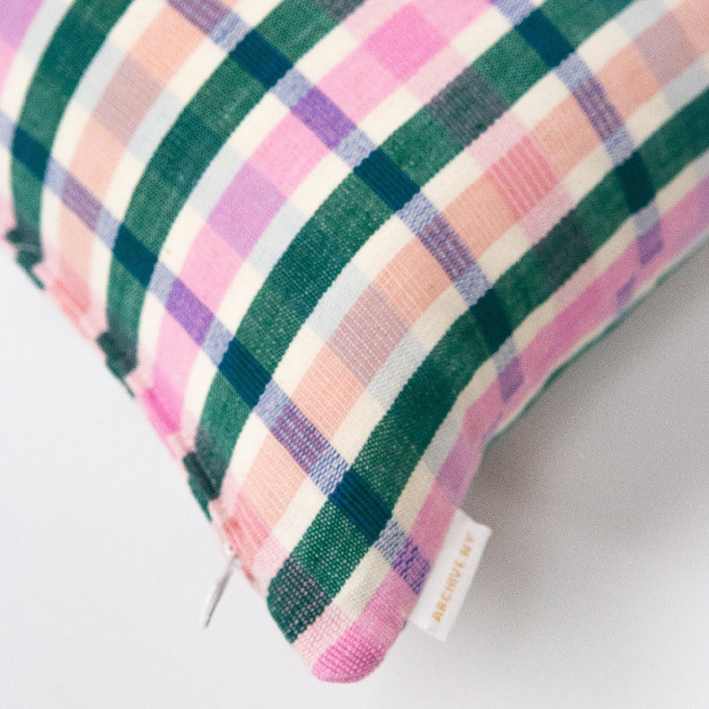 Organic cotton plaid pillow with pink, green, purple, and cream diagonal stripes in soft woven texture