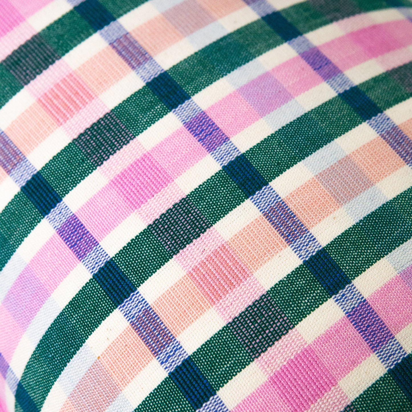 Woven plaid pillow with diagonal stripes in pink, teal, navy, purple, and cream textile pattern home décor accent