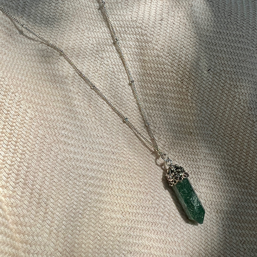 Green aventurine crystal pendant necklace with silver chain and ornate cap detail