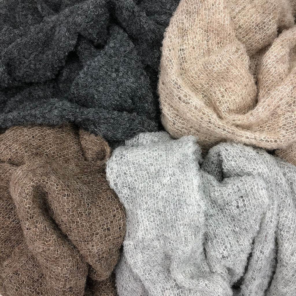 Charcoal, cream, taupe, and white ultra plush alpaca scarves with textured knit weave in neutral earth tones