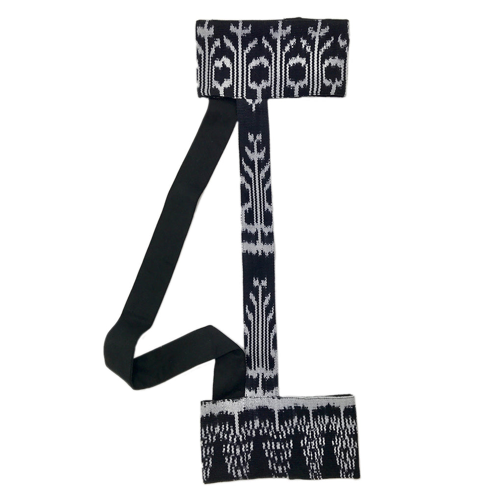 Black knit yoga mat sling with white botanical jacquard pattern and adjustable shoulder straps