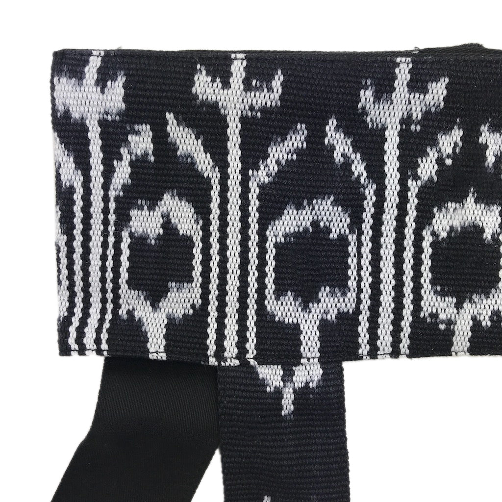 Black and white jacquard woven yoga mat sling with geometric cactus pattern and adjustable shoulder strap