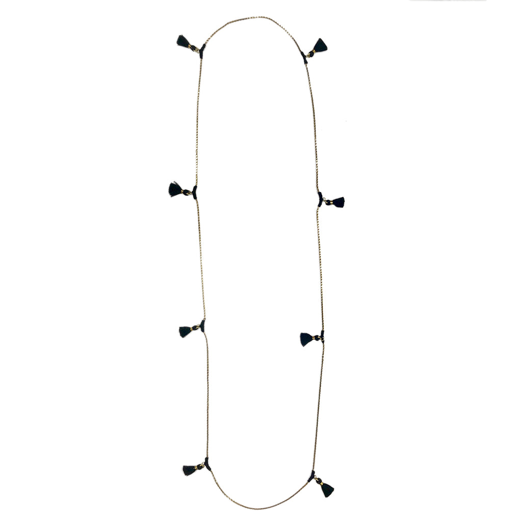 Long beaded necklace with black tassel charms, tan chain with bohemian style accents