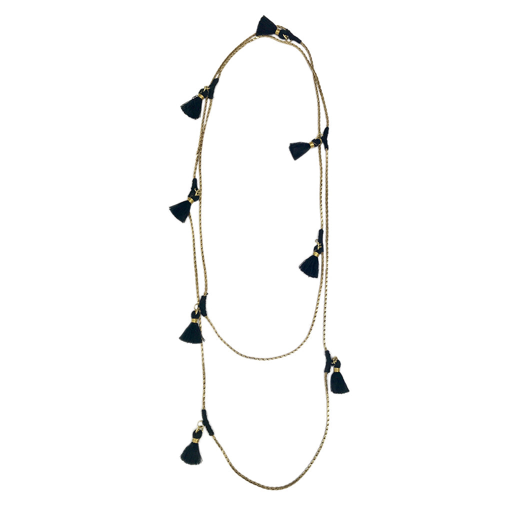Long layered necklace with natural linen cord and black tassel charms, gold-tone hardware accents