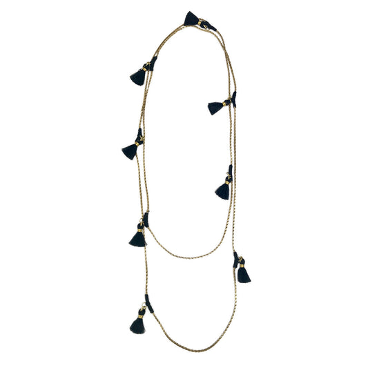 Long layered necklace with natural linen cord and black tassel charms, gold-tone hardware accents