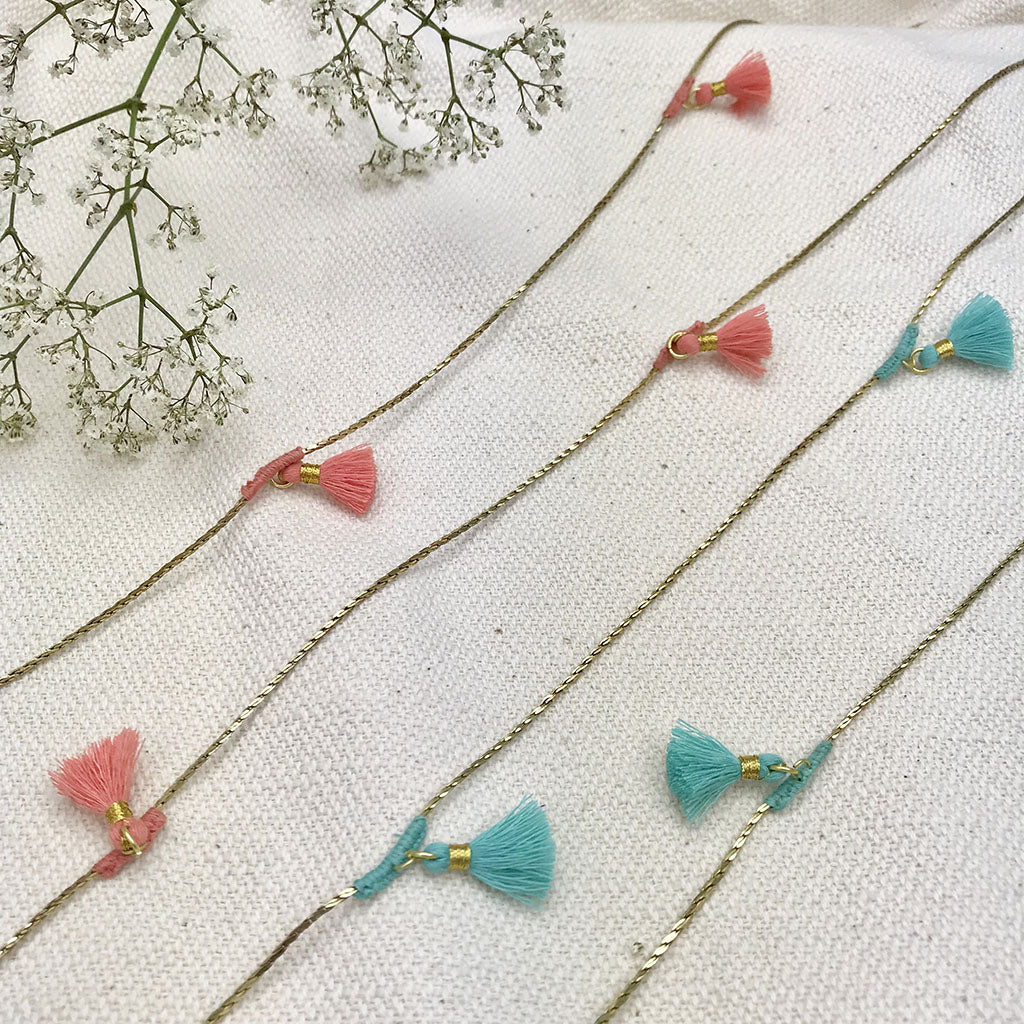 Tassel necklaces with coral and turquoise silk tassels on brass chains with gold accents